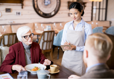 Family being served at a restaurant table