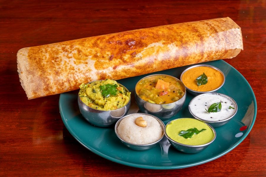 Masala dosa with chutneys and sambar