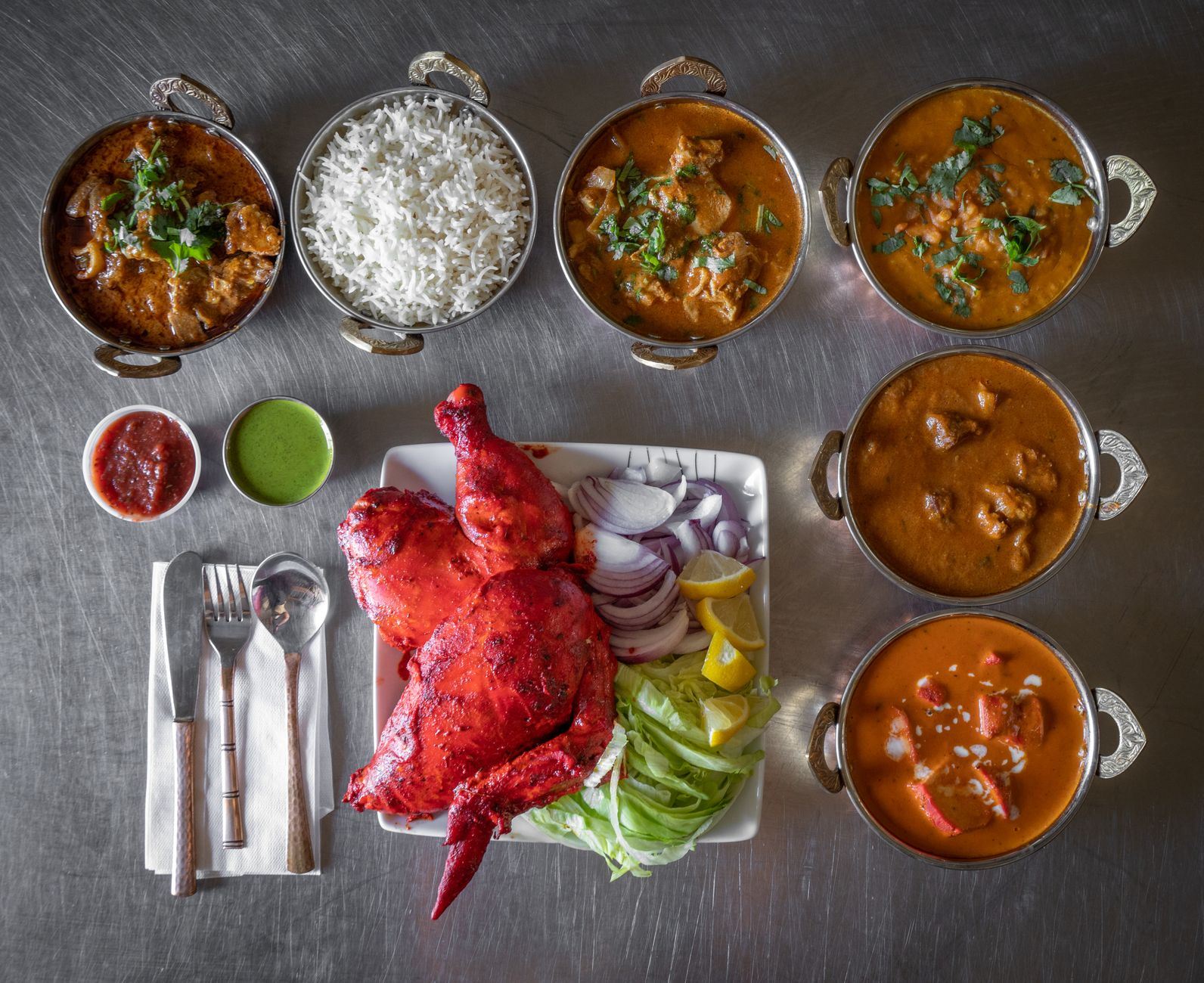 A spread of Indian curries, rice and tandoori dishes